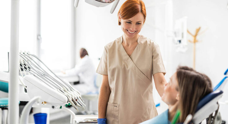 Patient in a dental chair during a check-up, illustrating the comparison between private dental practices and NHS dentists.